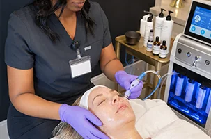 HydraFacial Greenville session with a licensed provider cleansing and hydrating a client's skin at Infinite Dripz