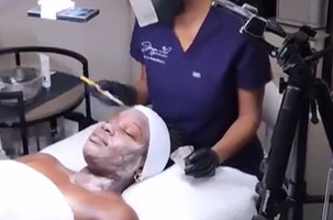 Client receiving a facial treatment at Infinite Dripz, offering HydraFacial and IV therapy Highland Park services.