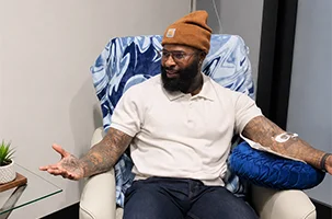 IV drip Greenville client relaxing in a lounge chair while receiving hydration and vitamin therapy