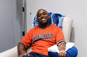 Man relaxing in a lounge chair during an IV drip Oak Lawn hydration and vitamin infusion session