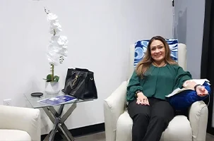 Client receiving a relaxing IV therapy session in a comfortable lounge chair near Uptown Dallas.