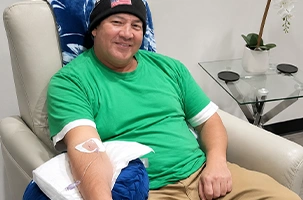 Gauze taped to his arm, a client relaxes in the chair after his Preston vitamin injection